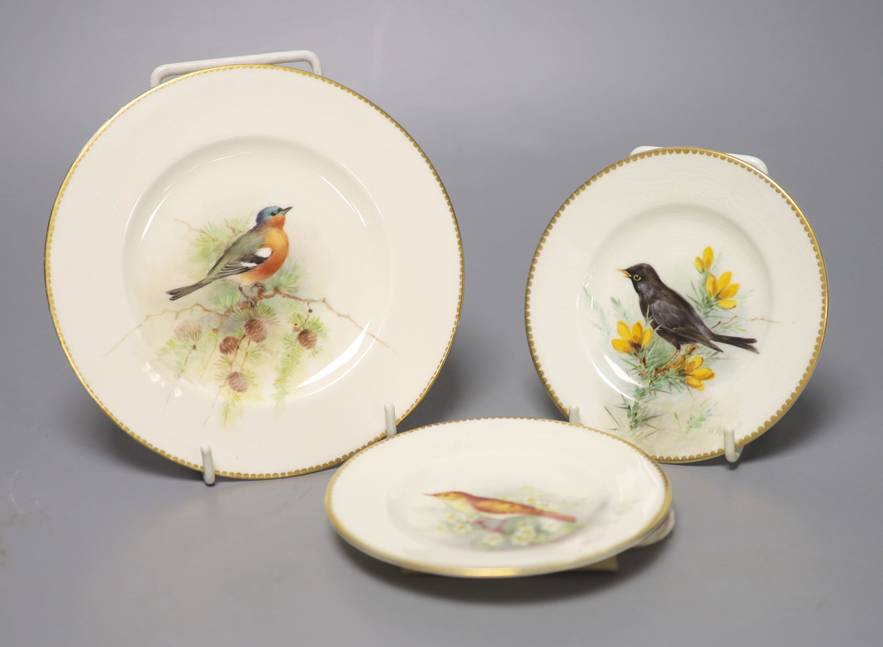 A pair of Royal Worcester plates and a single plate